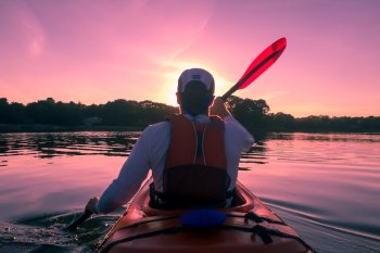 person inside kayak/lake