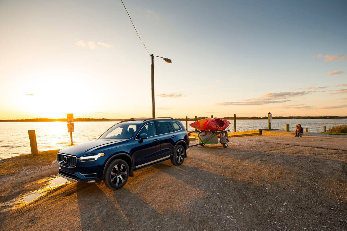 Blue Volvo SUV towing GO EASY with Kayaks (1200 x 800 px)